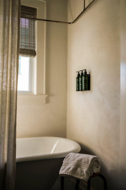 Bathroom with restored clawfoot tub in the Corner Suite.
