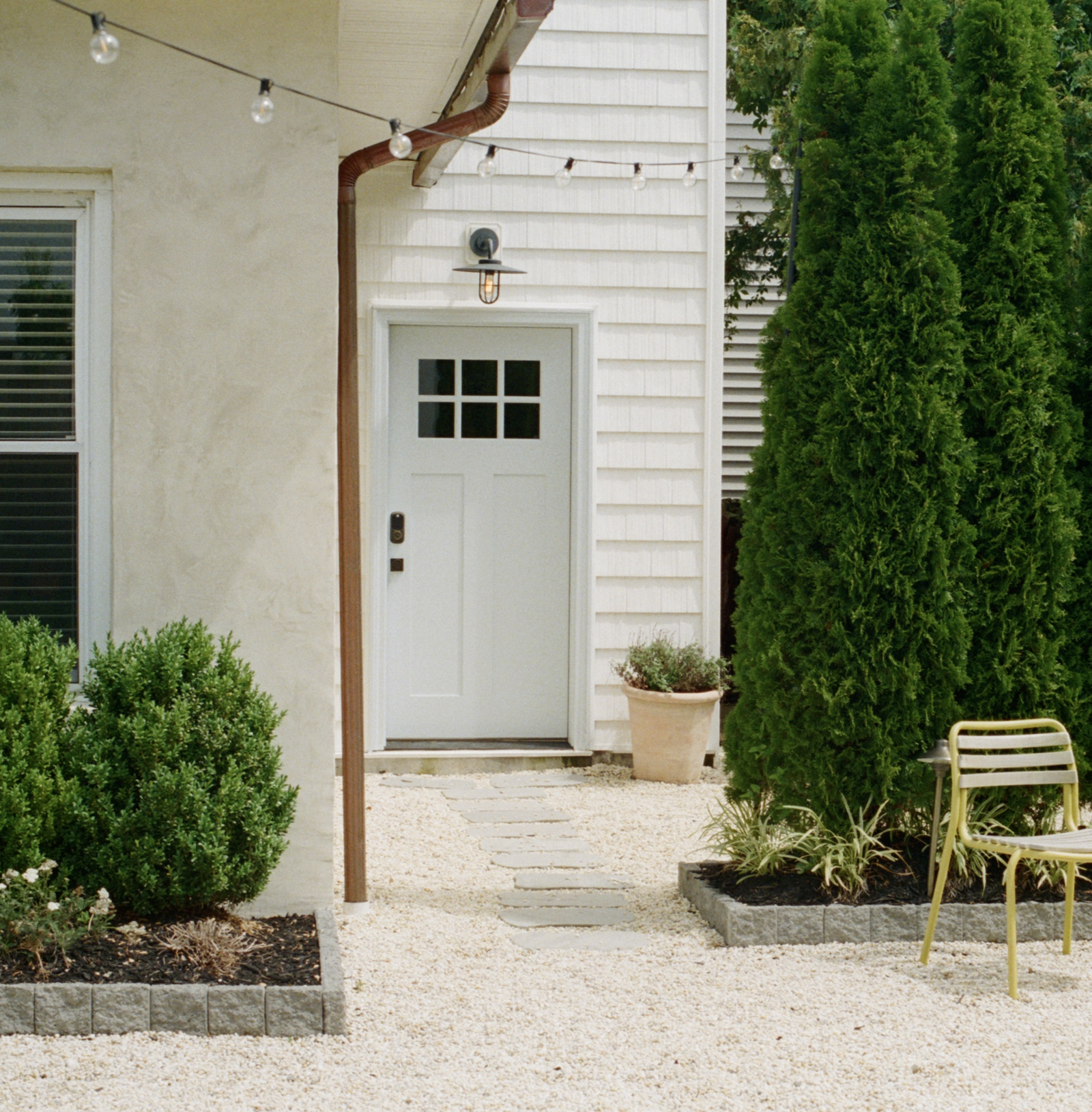 The James Bradley Bungalow featuring a private courtyard, refined residential exterior, and thoughtfully designed dining space.