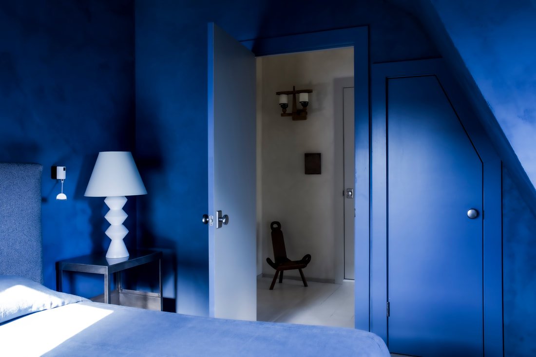 Light-filled bungalow bedroom featuring curated furnishings, soft neutral palette, and refined quiet